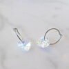 orhangen_titan_blomdahl_7330981158166_15-1255-02_d.jpg Heart-shaped crystal hoop earrings featuring a sparkling design, perfect for adding elegance to any outfit.