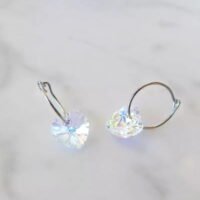 orhangen_titan_blomdahl_7330981158166_15-1255-02_d.jpg Heart-shaped crystal hoop earrings featuring a sparkling design, perfect for adding elegance to any outfit.