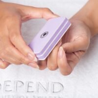 Supershine Depend lavender nail buffer held in hands, designed for smoothing and shaping nails, ideal for manicures and pedicures.
